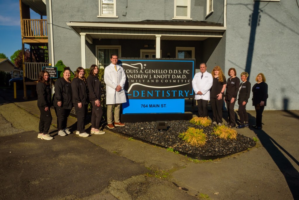 Dentist & Staff in front of office building